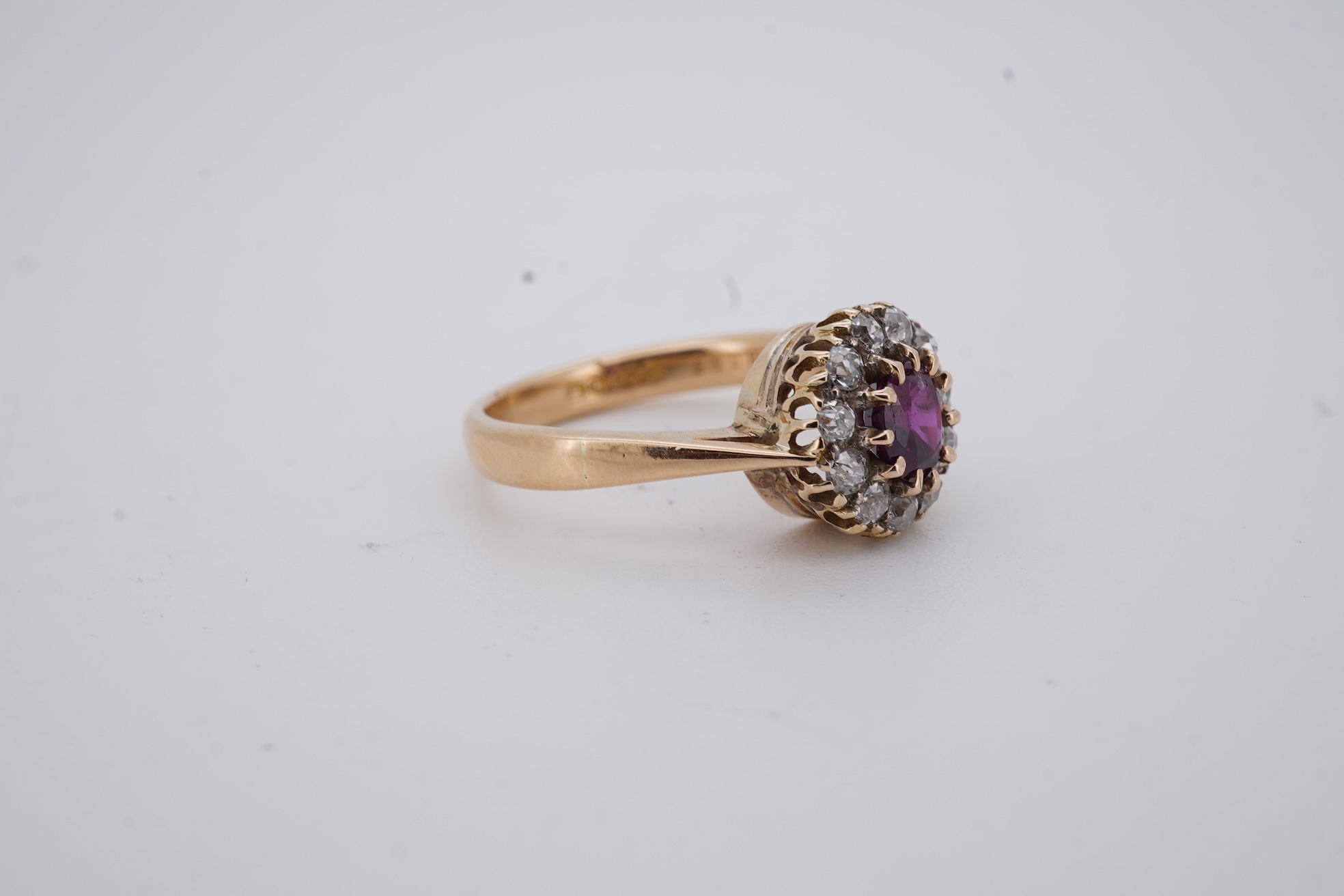 A George V 18ct gold, ruby and diamond set circular cluster ring, size M, gross weight 5 grams.